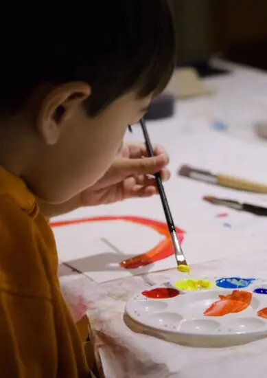 A young child painting at The Making Place.