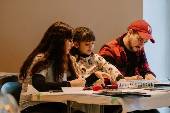 A family of three with a young child making art together at The Making Place