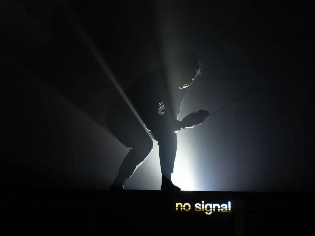 Silhouette of a person with text that says "no signal" in yellow.