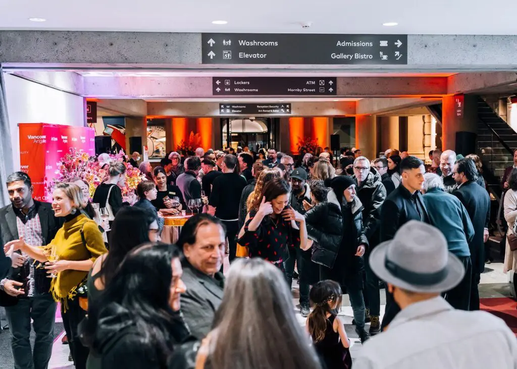 A crowd of people in the Gallery Lobby attending an exhibition opening reception.