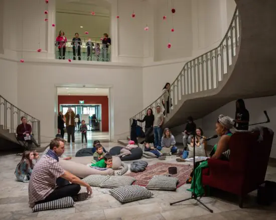 Families listen to a reading by Poet in Residence Jillian Christmas at Family Day in the 1st Floor Rotunda at the Vancouver Art Gallery