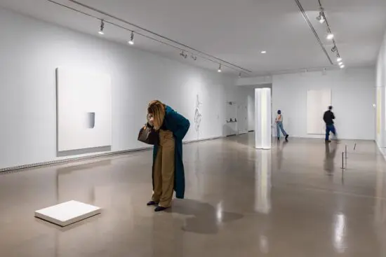 Gallery visitors looking at works in the exhibition Postcards from the Heart: Selections from the Brigitte and Henning Freybe Collection.