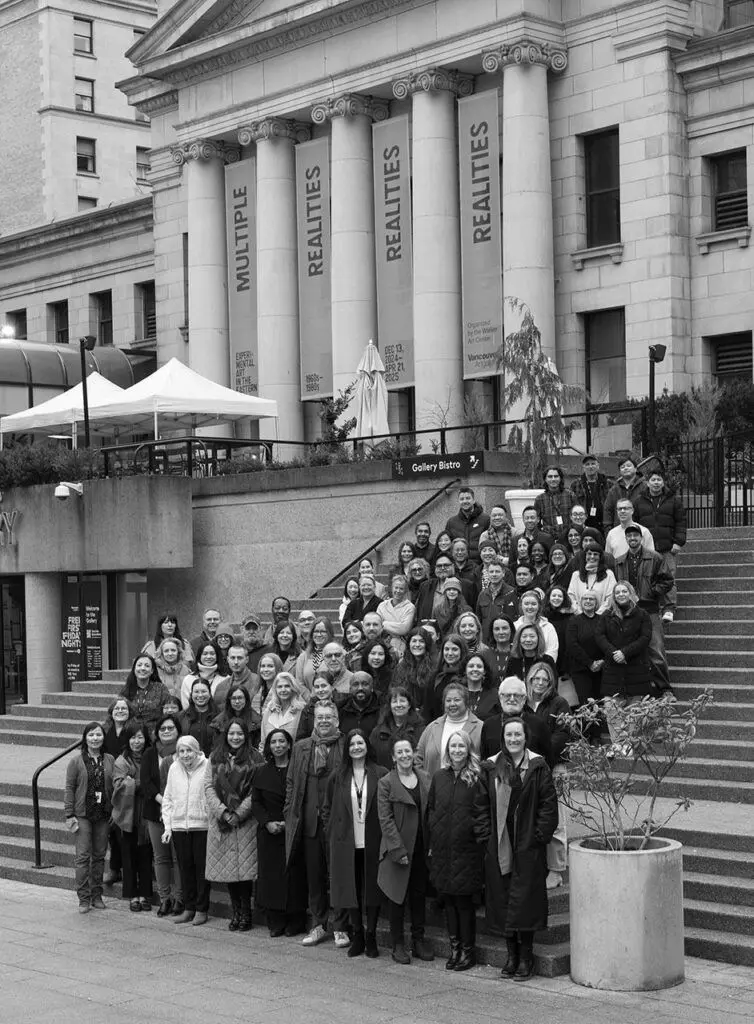 Gallery staff stand outside the Robson Street entrance of the Vancouver Art Gallery. Photo is in black and white.